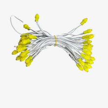 A bunch of 5-inch single color LEDs in various colors attached to copper wires, arranged in rows.