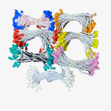 A bunch of 5-inch single color LEDs in various colors attached to copper wires, arranged in rows.