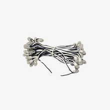 A bundle of 12-volt copper wire with single color SMD LEDs, approximately 5 inches apart, against a white background.
