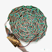 Coiled LED strip light with green lights on a white background