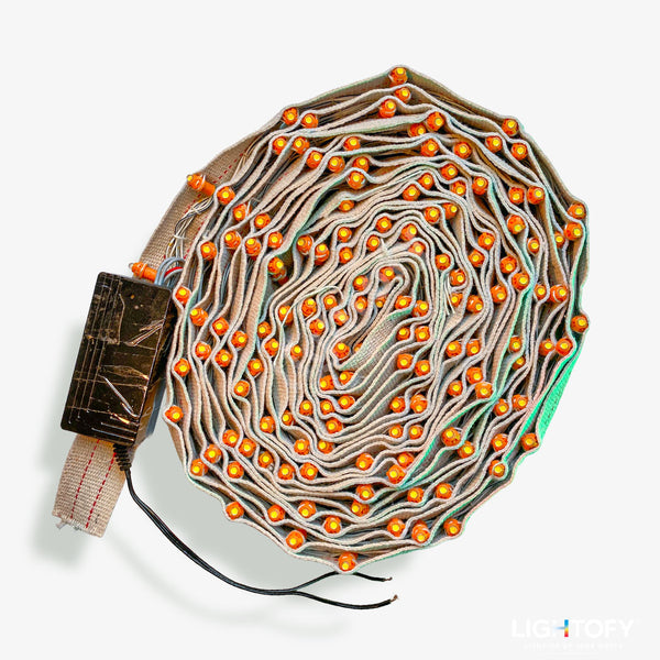 Coiled cable with orange lights on a white background