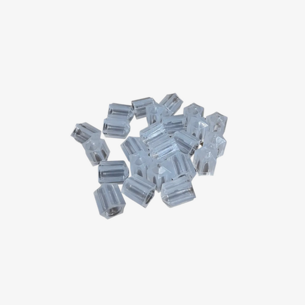 A collection of clear 12 volt LED caps scattered on a surface.