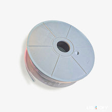 Spool of ribbon on a white background