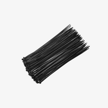 A collection of black and white 4-inch cable ties bundled together.