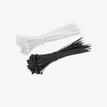 A collection of black and white 4-inch cable ties bundled together.