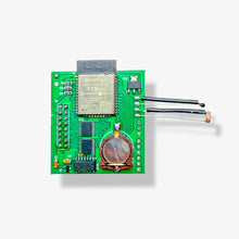 Green electronic circuit board with wireless components on a white background