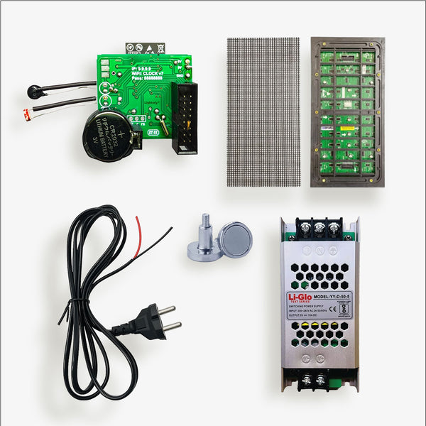 Electronic components including a green circuit board, power supply, and cables on a white background
