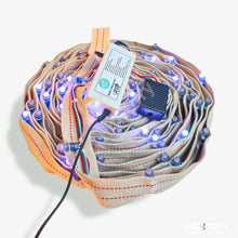 LED strip with connectors and a battery pack on a white background