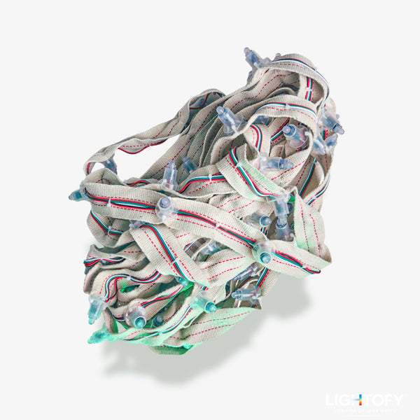String lights coiled into a ball on a white background