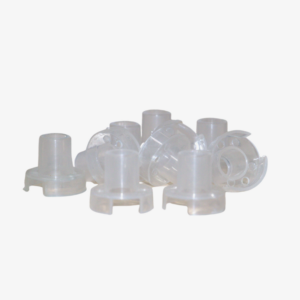 A collection of clear plastic pixel LED holders scattered on a surface.