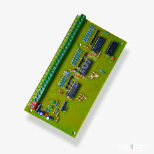 Green electronic circuit board with various components on a white background