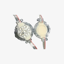 Two coin-shaped LED pixels with visible internal structure and attached wires for connectivity.