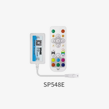 An SP548E SPI RGB IOT LED controller with a white exterior and a connected remote control, displaying various color buttons and a power button.