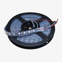 An addressable pixel LED strip with individual LEDs visible, connected to a microcontroller chip, and surrounded by a black casing.