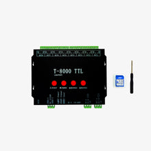 A T8000TTL controller with a black casing, several red ports labeled 'IN', 'OUT', and 'GND', and a blue card and tool for configuration.
