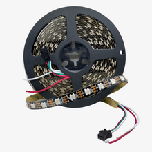 An addressable pixel LED strip with individual LEDs visible, connected to a microcontroller chip, and surrounded by a black casing.